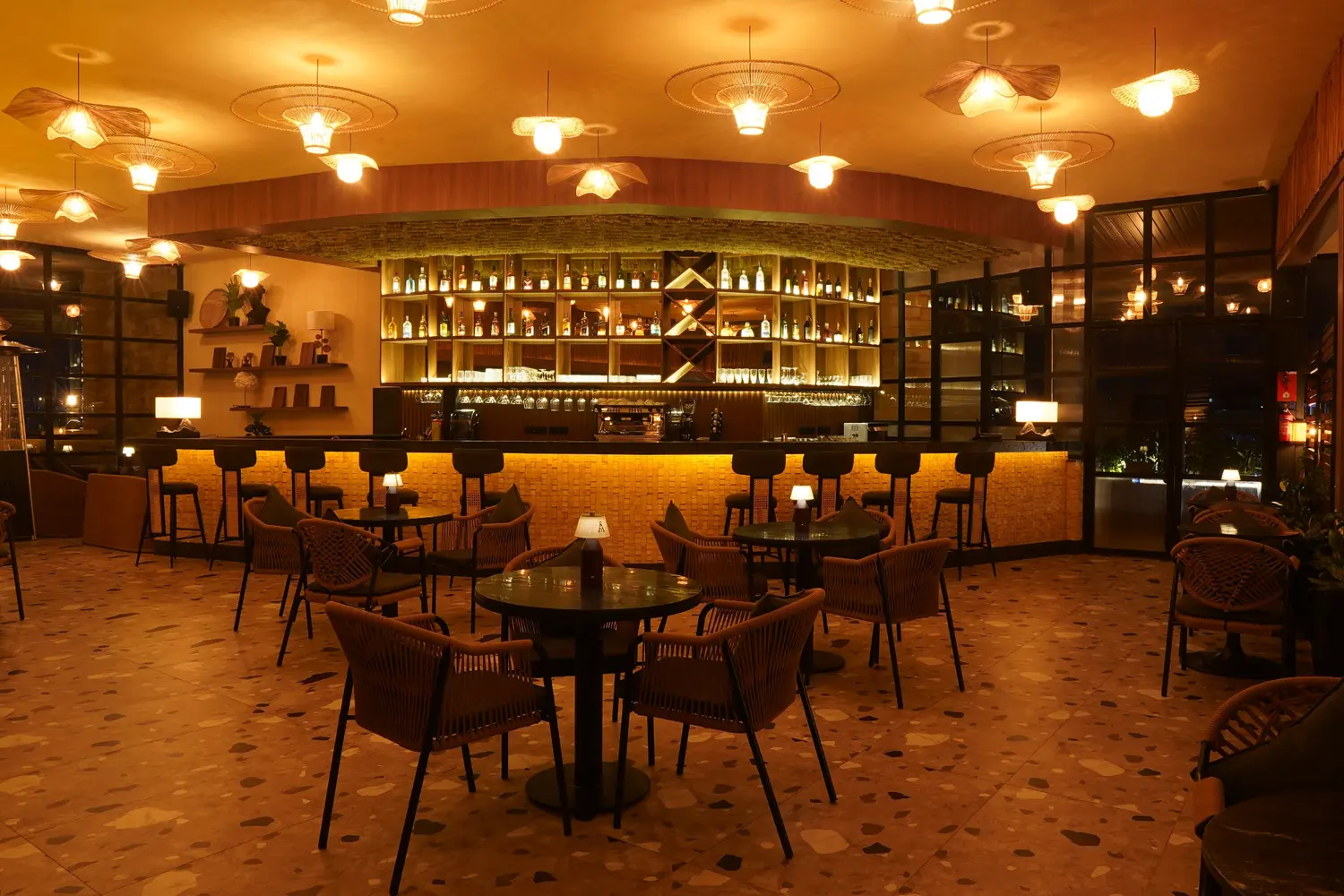 Ālaya bar counter under warm pendant lights