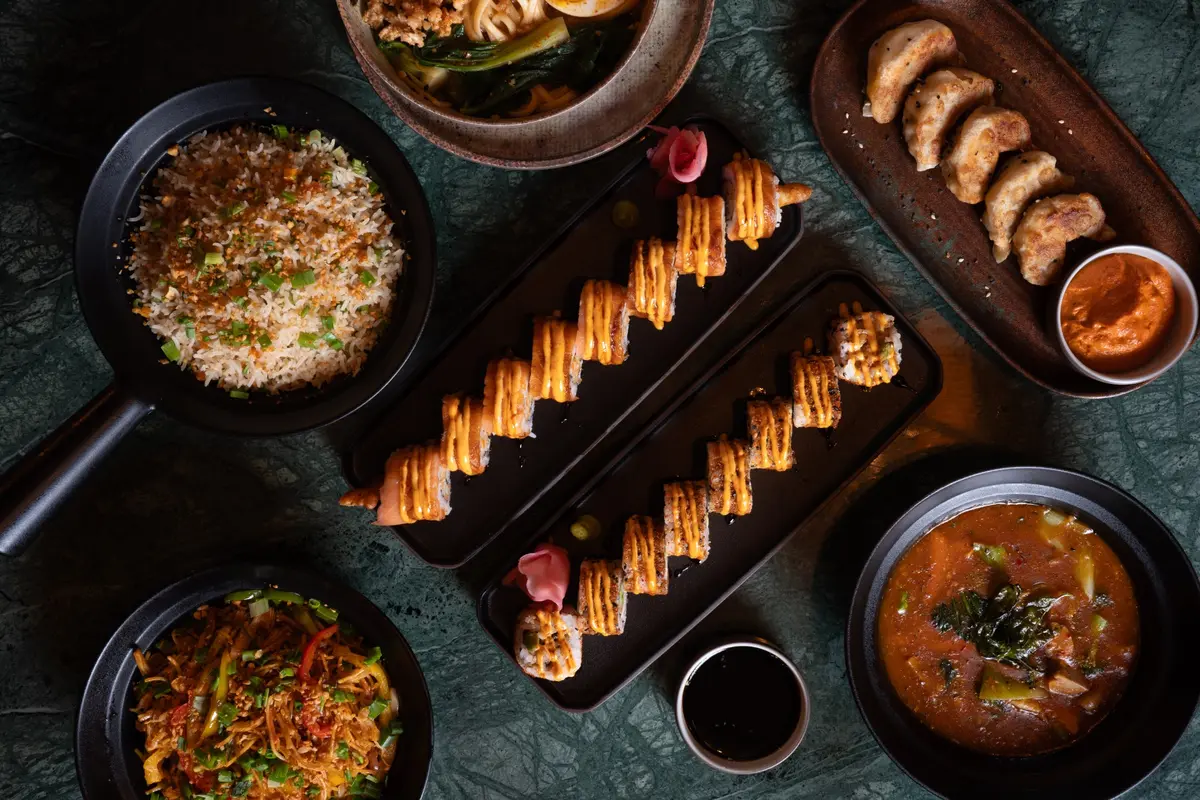 Sushi, dumplings and dishes arranged for the table