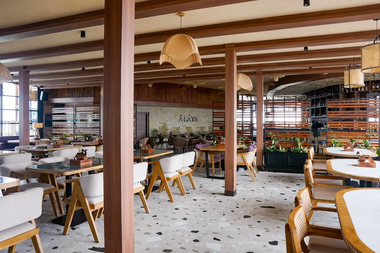 Ālaya’s daylight dining room with timber beams and pendant lights